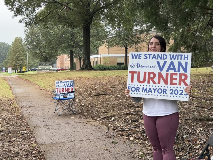 <strong>Jessica Hendrix waves to drivers and holds a sign for Van Turner along Colonial Road at White Station Church of Christ.</strong> (Abigail Warren/The Daily Memphian)