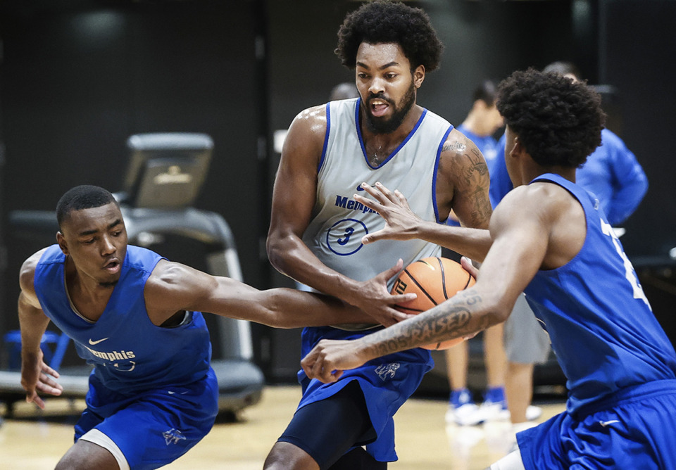 <strong>University of Memphis forward Jordan Brown (middle) drives the lane against defenders Jayhlon Young (left) and Jayden Hardaway (right) during practice on Sept. 27. Brown&nbsp;earned a spot on the preseason All-AAC second team.</strong> (Mark Weber/The Daily Memphian file)