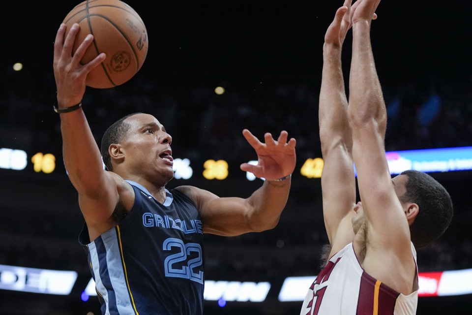 <strong>Memphis Grizzlies guard Desmond Bane (22) jumps to shoot past Miami Heat forward Cole Swider during an NBA preseason basketball game, Sunday, Oct. 15, in Miami.</strong> (Rebecca Blackwell/AP Photo)