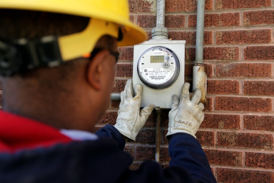 <strong>Nate Guyton of Memphis Light, Gas and Water installs a smart meter on a house in the Cooper-Young area.</strong> (Daily Memphian file)