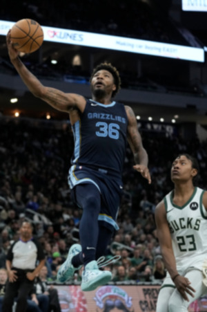 Memphis Grizzlies' Marcus Smart shoots past Milwaukee Bucks' TyTy Washington Jr. during the second half of a preseason NBA basketball game Friday, Oct. 20, 2023, in Milwaukee. (AP Photo/Morry Gash)