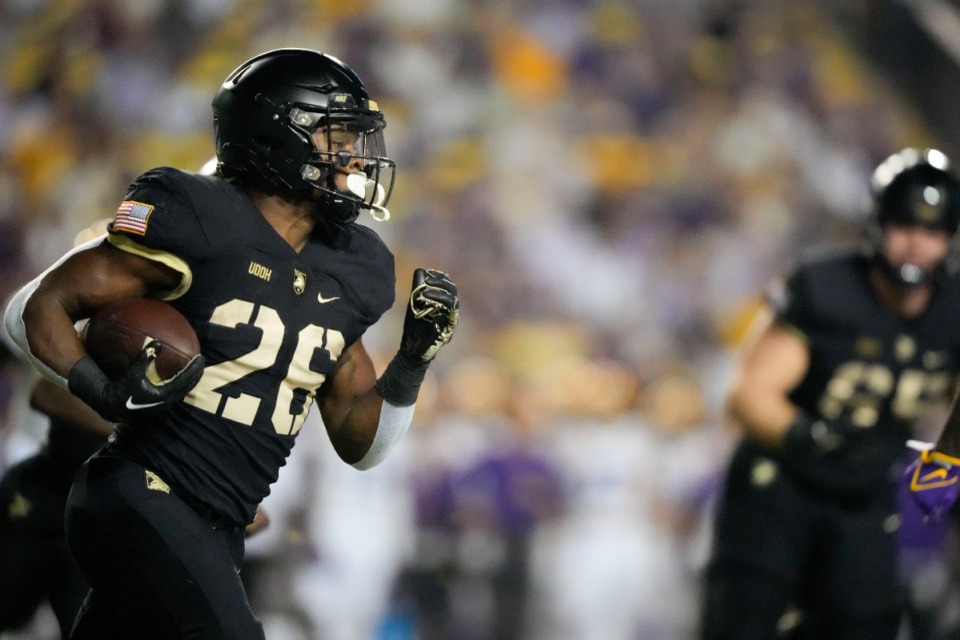 <strong>Army running back Kanye Udoh (26) carries in the first half of an NCAA college football game against LSU in Baton Rouge, La., Oct. 21.</strong> (Gerald Herbert/AP file)