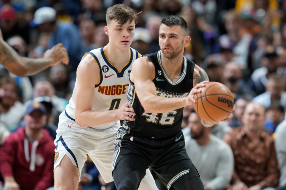 <strong>Memphis Grizzlies guard John Konchar, front, looks to pass the ball as Denver Nuggets guard Christian Braun defends in the first half of an NBA basketball game Tuesday, Dec. 20, 2022, in Denver.</strong> (AP Photo/David Zalubowski)