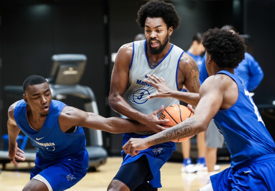 <strong>University of Memphis forward Jordan Brown (middle) drives the lane against defenders Jayhlon Young (left) and Jayden Hardaway (right) during practice on Wednesday, Sept. 27, 2023</strong>. (Mark Weber/The Daily Memphian)