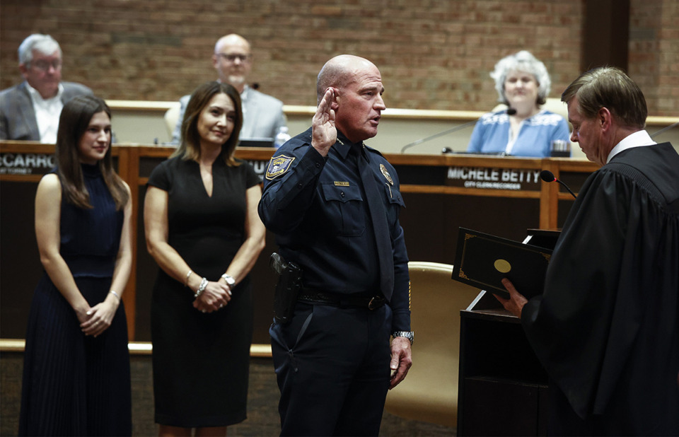 <strong>Germantown new Police Chief Mike Fisher (middle) is sworn in during a Germantown Board of Mayor and Aldermen meeting on Monday, October 23, 2023 while his wife and daughter stand behind him.</strong> (Mark Weber/The Daily Memphian)