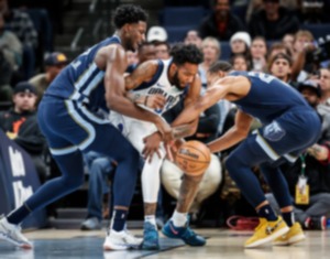 <strong>Memphis Grizzlies center Jaren Jackson Jr., (left) and guard Desmond Bane (right) steal the ball from Dallas Mavericks forward Derrick Jones Jr. (middle) on Oct. 30, 2023.</strong> (Mark Weber/The Daily Memphian)