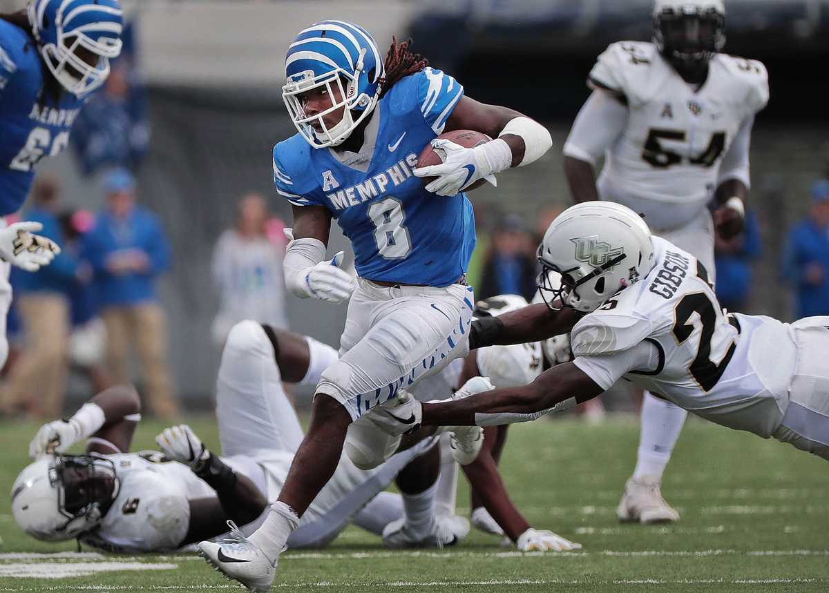 <strong>University of Memphis running back Darrell Henderson (8) breaks a tackle on a run during the Tigers' disappointing 31-30 loss to UCF at the Liberty Bowl Memorial Stadium on Oct. 13, 2018.</strong> (Jim Weber/Daily Memphian)