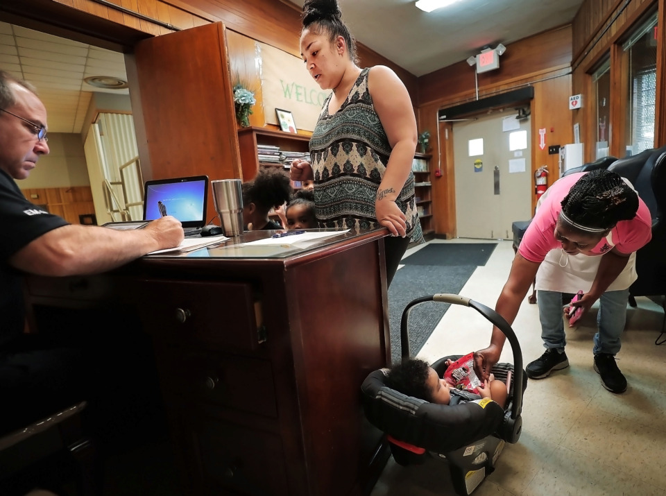 <strong>After a storm knocked out power to parts of the city Wednesday evening, LaNora Arnold (center) checks in with her four children at a cooling center established by the city of Memphis at the Lewis Senior Center on June 21, 2019.&nbsp;Memphians are experiencing more heat-related deaths and emergency room visits as the number of high-heat days increases, according to a review of weather and health statistics.</strong>&nbsp; (Jim Weber/Daily Memphian)