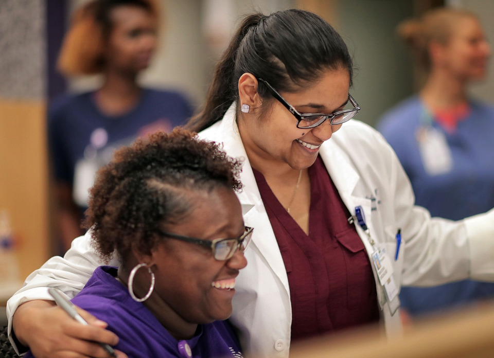 <strong>Church Health resident Dr. Marisha Sirdar jokes with medical assistant Ashley Nolen at the clinic in Crosstown Concourse on Friday, June 21. This week, the first four residents will graduate from a family medicine program created through a partnership between Church Health and Baptist Memorial Health Care Corp.</strong> (Jim Weber/Daily Memphian)