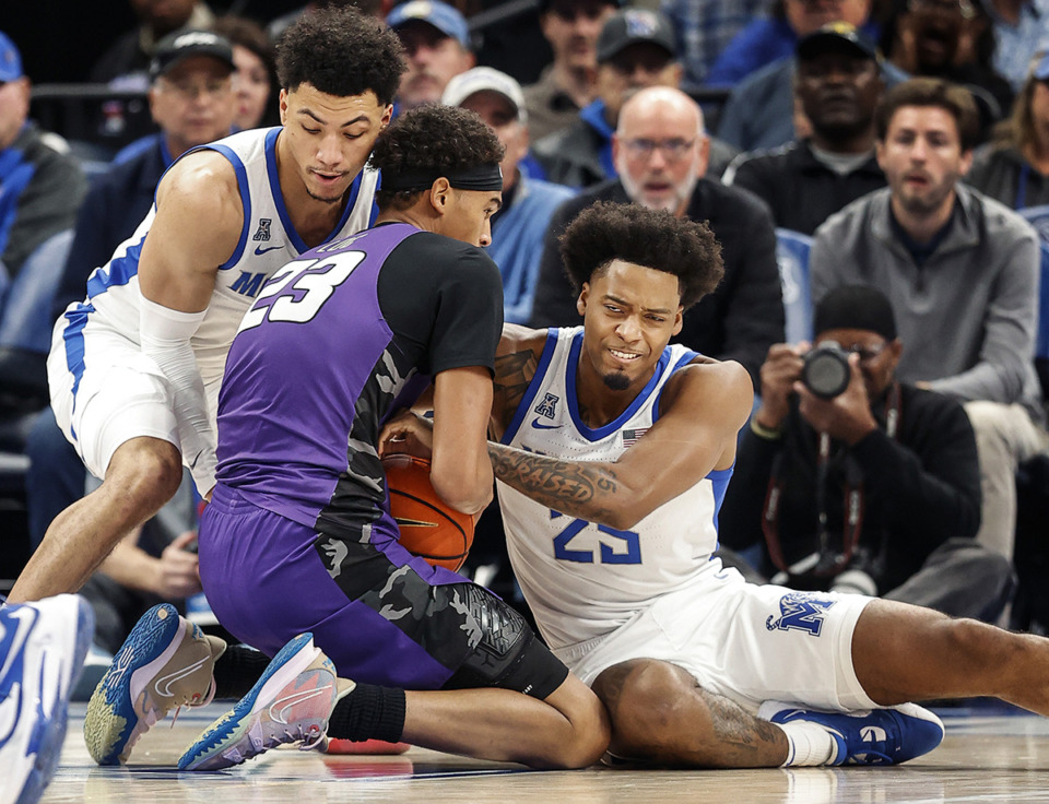 <strong>Memphis Tigers teammates Jahvon Quinerly (left) and Jayden Hardaway (right) battle LeMoyne-Owen College forward Matt Spears (middle) for a loose ball during action on Nov. 2.</strong> (Mark Weber/The Daily Memphian)