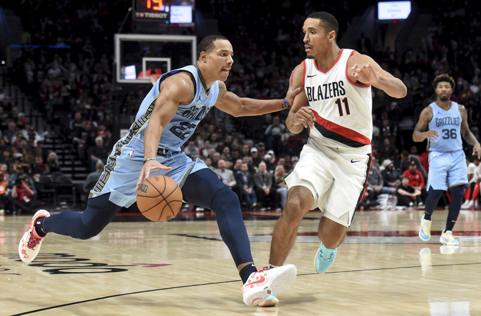 <strong>Memphis Grizzlies guard Desmond Bane, left, drives to the basket against Portland Trail Blazers guard Malcolm Brogdon (11) during a game in Portland, Ore., Sunday, Nov. 5.</strong> (Steve Dykes/AP Photo)