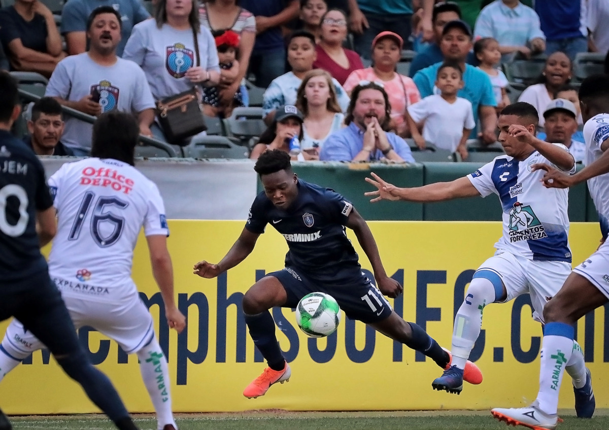 <strong>Memphis forward Lagos Kunga is tripped up by a Pachuca defender during 901 FC's 6-1 loss to the squad from Mexico.</strong> (Jim Weber/Daily Memphian)