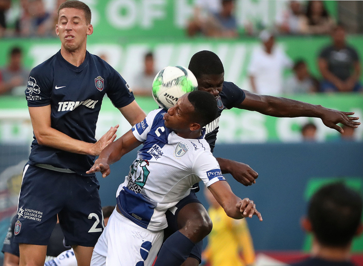 <strong>Memphis defender Josh Morton (left) and midfielder Ewan Grandison collide Saturday with Pachuca forward Jonathan Copete during 901 FC's 6-1 loss to the squad from Mexico.</strong> (Jim Weber/Daily Memphian)