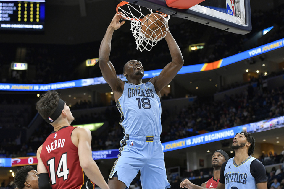 <strong>Memphis Grizzlies center Bismack Biyombo (18) dunks ahead of Miami Heat guard Tyler Herro (14) in the first half of an NBA basketball game, Wednesday, Nov. 8, in Memphis.</strong> (Brandon Dill/AP Photo)