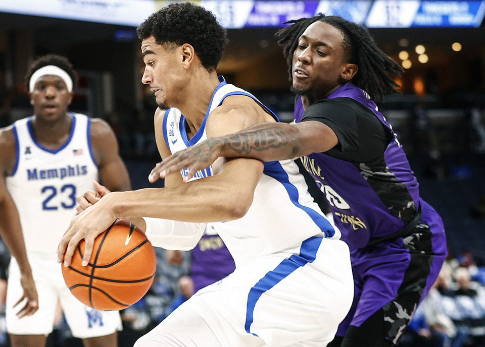 <strong>Memphis Tigers forward Jonathan Pierre (left) drives to the basket past LeMoyne-Owen College defender Tariq Shepherd (right) during action on Thursday, November 2, 2023. Pierre and Jayhlon Young have reiterated their national title aspirations.</strong> (Mark Weber/The Daily Memphian)