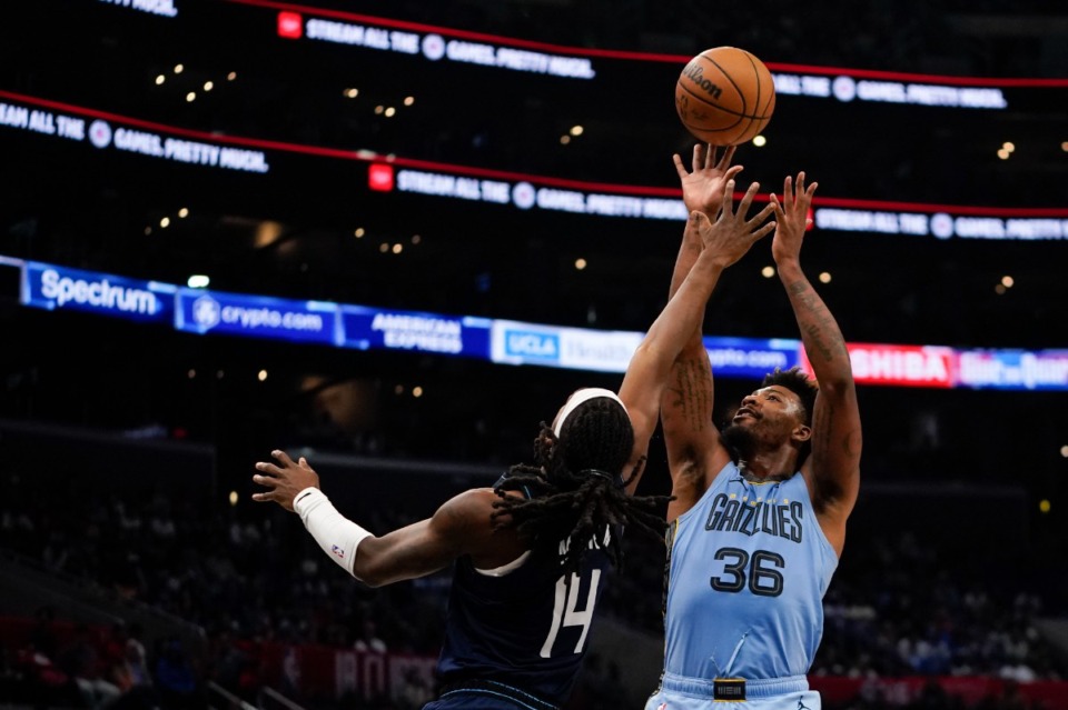 <strong>Memphis Grizzlies guard Marcus Smart, right, shoots against Los Angeles Clippers guard Terance Mann during the second half of an NBA basketball game, Sunday, Nov. 12, 2023, in Los Angeles.</strong> (AP Photo/Ryan Sun)