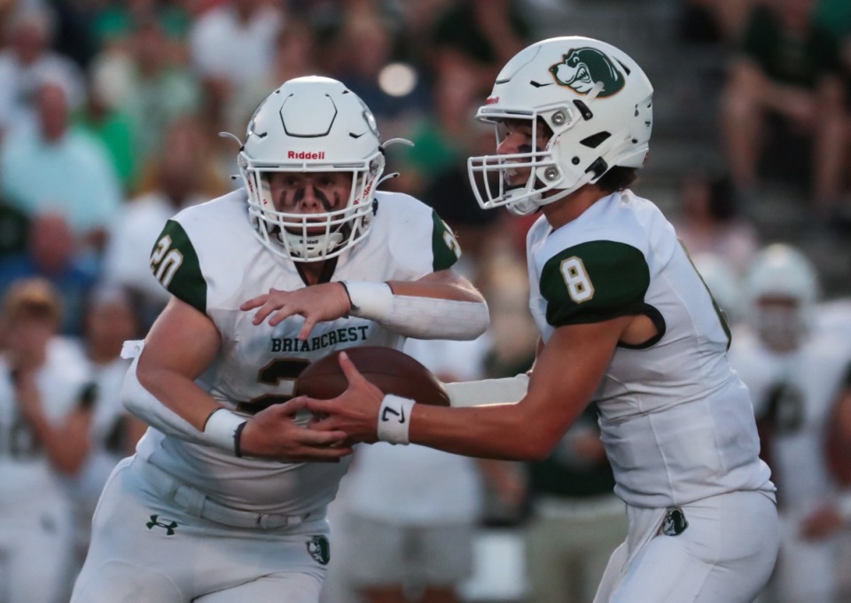 <strong>Briarcrest quarterback Cade Carlson (8) hands the ball off to running back Taylor Logan (20) durng a Aug. 26, 2022 game against Houston.</strong> (Patrick Lantrip/The Daily Memphian file)