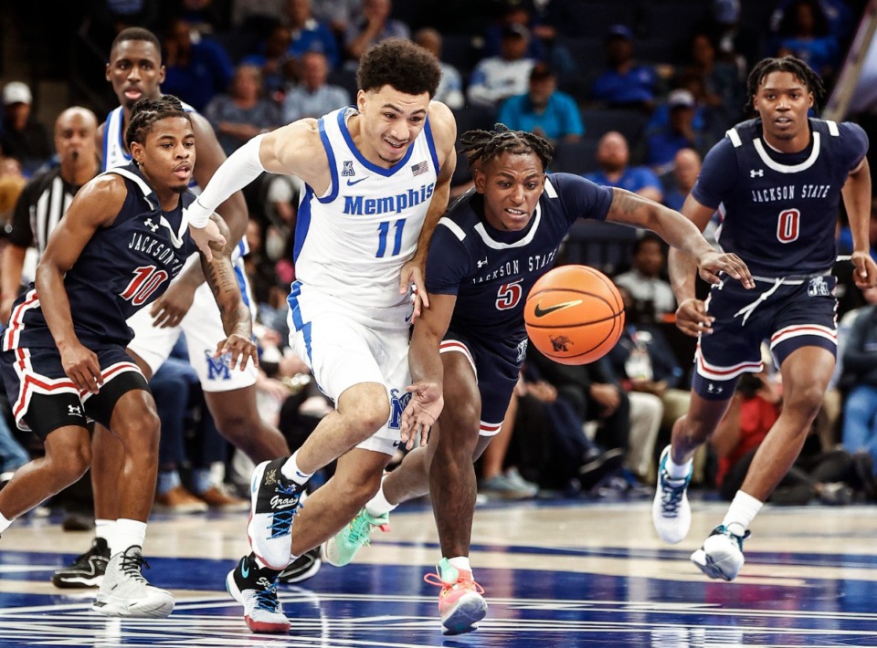 <strong>University of Memphis guard Jahvon Quinerly (middle) battles Jackson State defender Keiveon Hunt (second right) for a loose ball during action on Monday Nov. 6, 2023.</strong> (Mark Weber/The Daily Memphian)