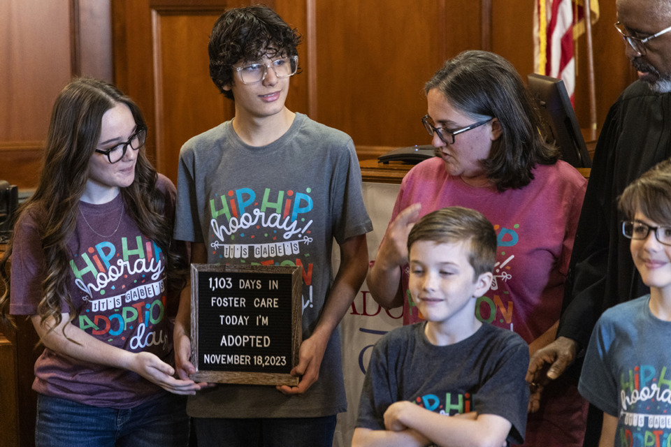 <strong>Gabe Russell (second from left), stands with his family after being adopted during the National Adoption Day event at the Chancery Court of Shelby County, Tennessee. Twenty-three adoptions took place on the morning of National Adoption Day, Nov. 18.</strong> (Brad Vest/Special to The Daily Memphian)