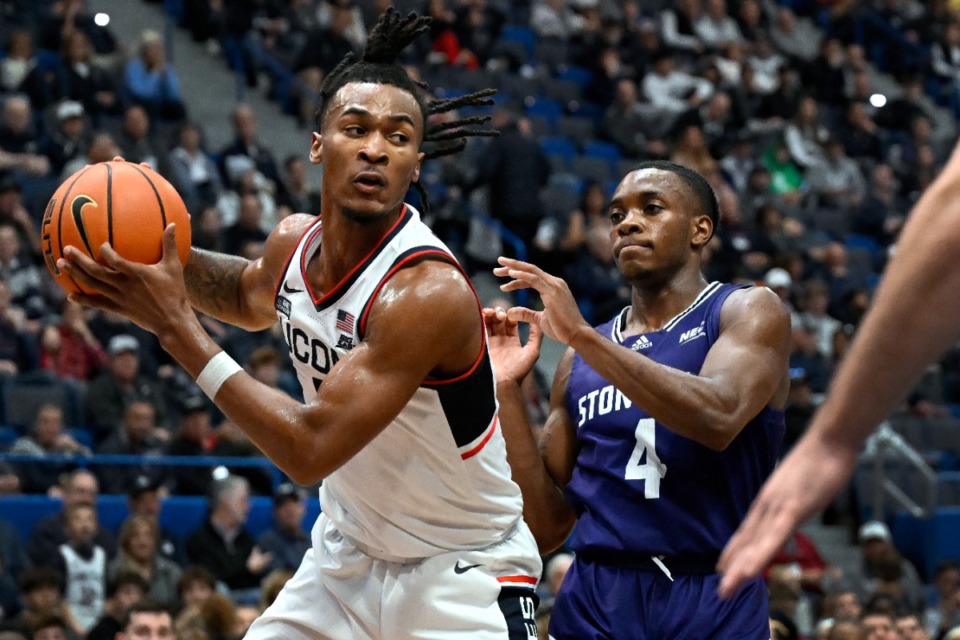 <strong>UConn's Stephon Castle pulls down a rebound as Stonehill's Se'yphon Triplett defends in the second half of an NCAA college basketball game, Saturday, Nov. 11, 2023, in Hartford, Conn.</strong> (AP Photo/Jessica Hill)