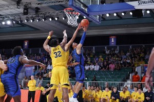 <strong>Memphis' Jahvon Quinerly, right, shoots while Michigan's Tarris Reed Jr. blocks the first game of the Battle 4 Atlantis at Paradise Island, Bahamas, Wednesday, Nov. 22.</strong> (Tim Aylen/Bahamas Visual Services via AP)