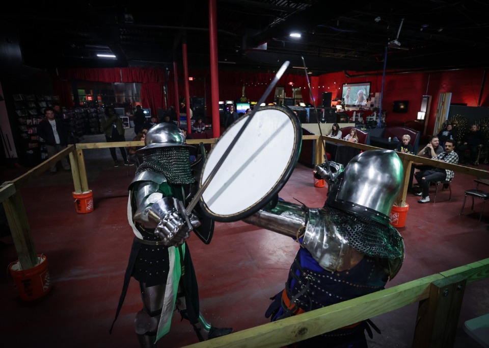 <strong>Logan Sanders (left) and Cole de Jongh compete in a sword and shield match at Memphis Armored Fight Club's monthly event at the Black Lodge on Saturday, Nov. 25, 2023.</strong> (Patrick Lantrip/The Daily Memphian)