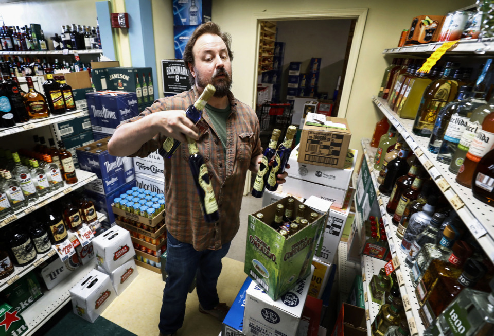 <strong>Kimbrough Wine &amp; Spirits employee George Edis stocks shelves June 26, 2019, at the Midtown Memphis liquor store. The owners of the store,&nbsp;<span>Doug and Mary Ketchum,</span> won their fight against Tennessee&rsquo;s two-year residency requirement to operate a liquor store after the U.S. Supreme Court voted 7-2 against the law.&nbsp;</strong>(Mark Weber/Daily Memphian)
