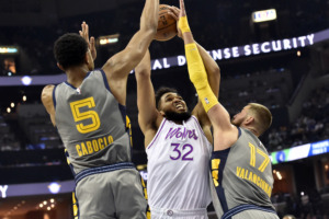 <span><strong>Minnesota Timberwolves center Karl-Anthony Towns (32) shoots against Memphis Grizzlies center Jonas Valanciunas (17) and forward Bruno Caboclo (5) in the second half of an NBA basketball game Saturday, March 23, 2019, in Memphis, Tenn.</strong> (AP Photo/Brandon Dill)</span>