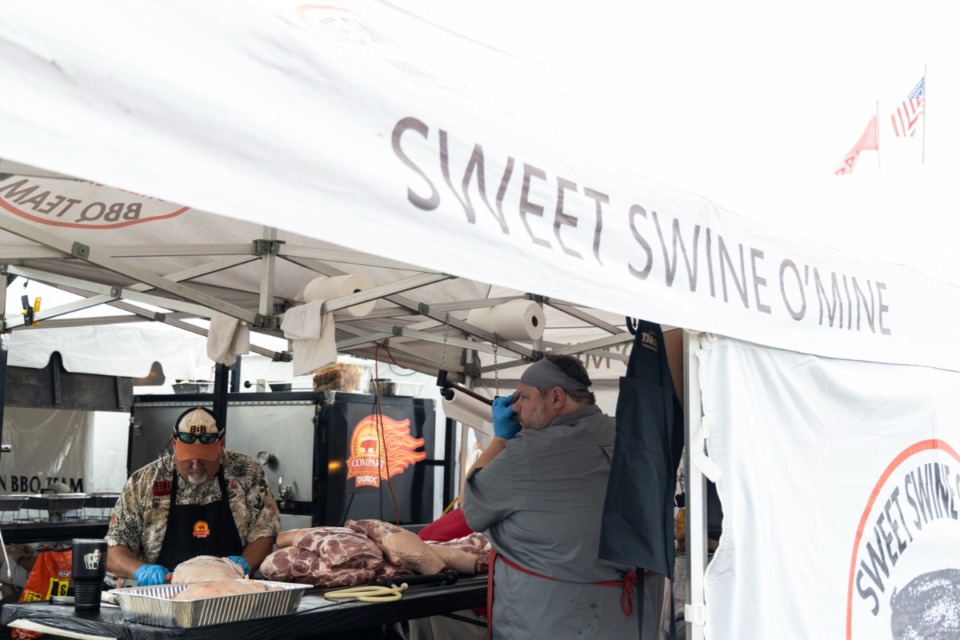 <strong>Team members from Sweet Swine O&rsquo;Mine work on their meats during the Memphis in May World Championship Barbecue Cooking Contest at Tom Lee Park on May 19.</strong> (Brad Vest/The Daily Memphian file)