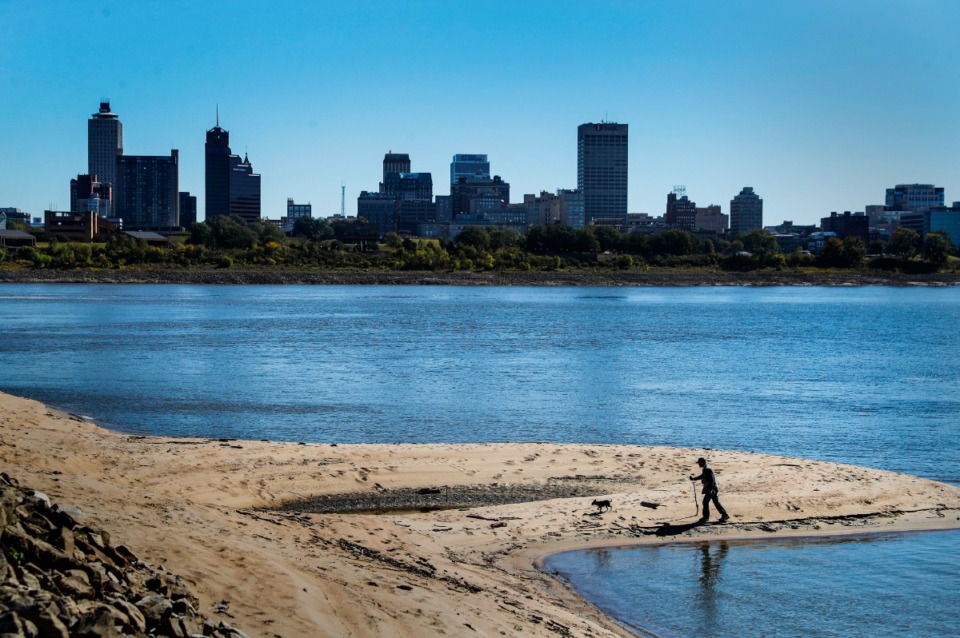 <strong>Marion, Ark., resident Douglas Music and his dog Pumpkin search for treasures and artifacts on a large sandbar along the Mississippi River in Memphis amid historically low water levels caused by drought in late October 2022.</strong> (Mark Weber/The Daily Memphian file)
