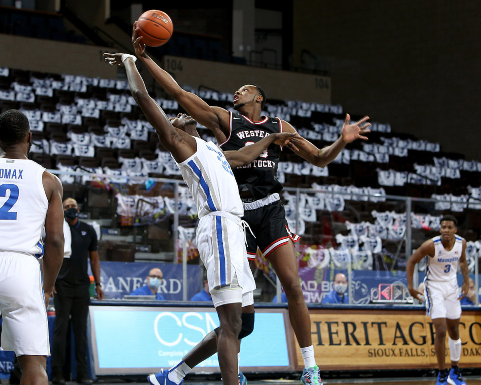 <strong>Charles Bassey (23) of the Western Kentucky Hilltoppers grabs a rebound over Moussa Cisse (32) of the Memphis Tigers during the Bad Boy Mowers Crossover Classic at the Sanford Pentagon in Sioux Falls, S.D.</strong> (Dave Eggen/Inertia)