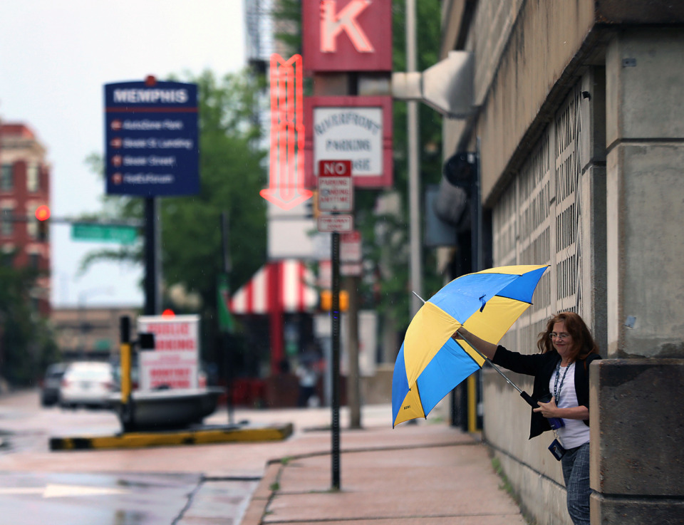 <strong>Renee Graves readies her umbrella as she leaves a Downtown Memphis parking garage during a rainy Thursday, June 27, 2019. A comprehensive parking study found more than 20% of spaces Downtown and in the Medical District go unused during the busiest parts of the workweek.</strong>&nbsp;(Patrick Lantrip/Daily Memphian)
