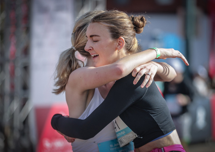 <strong>McKenna Lessley hugs her friend, Madison McKinstry, after completing the St. Jude Memphis Marathon Dec. 2.</strong> (Patrick Lantrip/The Daily Memphian)