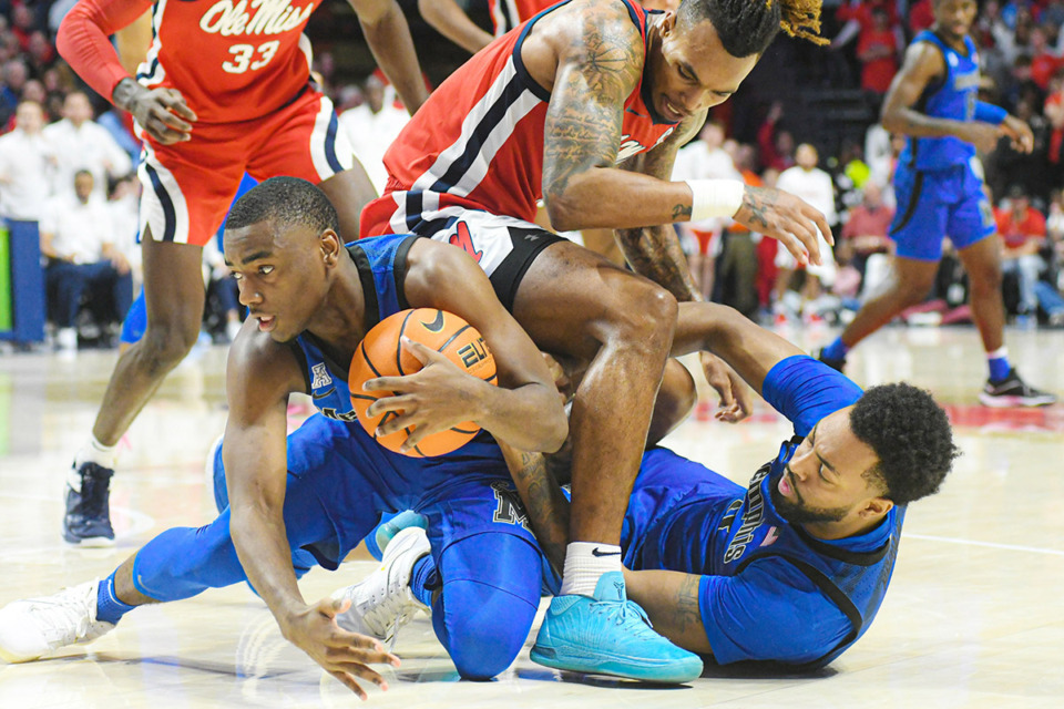 <strong>Memphis Tigers guard Jayhlon Young (1), Ole Miss Rebels guard Allen Flanigan (7), and Memphis Tigers center Jordan Brown (3) battle for the ball at the Sandy and John Black Pavilion at Ole Miss on Saturday, Dec. 2, 2023. Ole Miss won 80-77.</strong> (Bruce Newman/Special to The Daily Memphian)