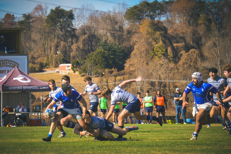 <strong>Harry Hagan (8) holds the ball as he makes an off-load to Musa Banat (2) while he is tackled during the quarterfinal game versus Georgetown University in Knoxville&nbsp;at the Tennessee Rugby Park on Nov. 19.</strong> (Courtesy Dat Hoang)