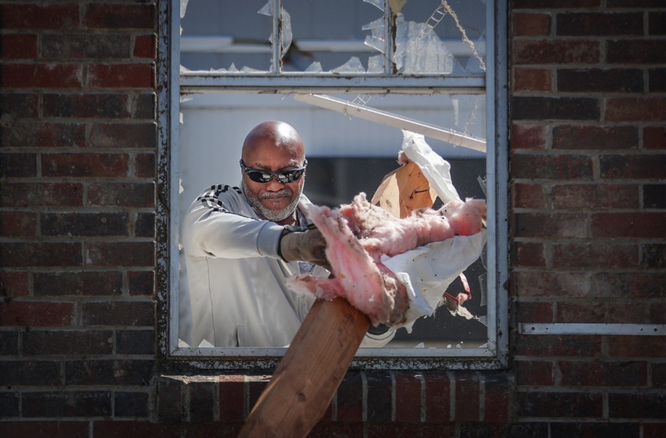<strong>Joseph Mack helps his neighbor clean up his house in Covington on April 1, 2023 after it was hit by tornado the night before.</strong> (Patrick Lantrip/The Daily Memphian)