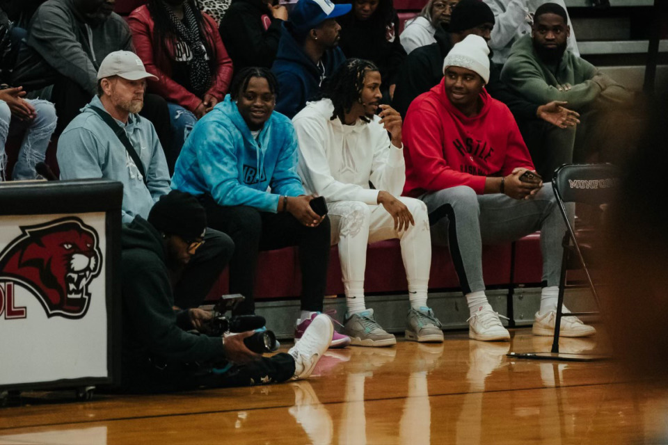 <strong>Memphis Grizzlies point guard Ja Morant (in white) has been spending time with the Munford High basketball team. With Morant at a Munford game were (from left) Kevin Helms, former head of Grizzlies security, Davonte Pack and Darnell Cowart.</strong> (Courtesy David Perry)