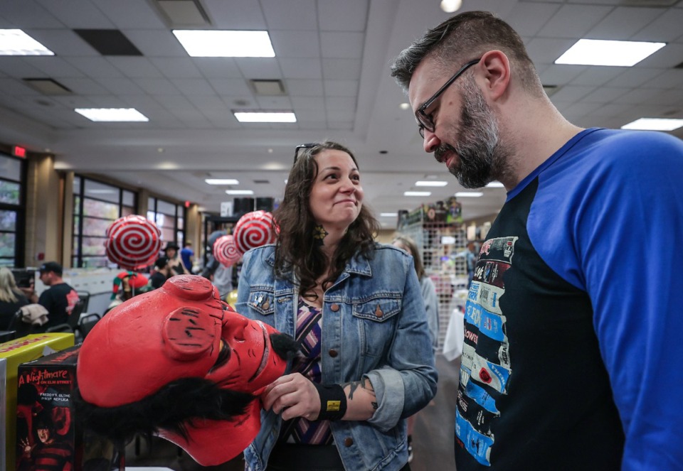 <strong>Vanessa Waites and Chris Haley check out a Hellboy mask while shopping at MidSouth Toy Fest Saturday, Dec. 9 at the Great Hall &amp; Conference Center in Germantown. Harry Koniditsiotis&nbsp;and&nbsp;Barry Scott were organizers of the event, which featured more than 50 vendors.</strong>&nbsp;(Patrick Lantrip/The Daily Memphian)