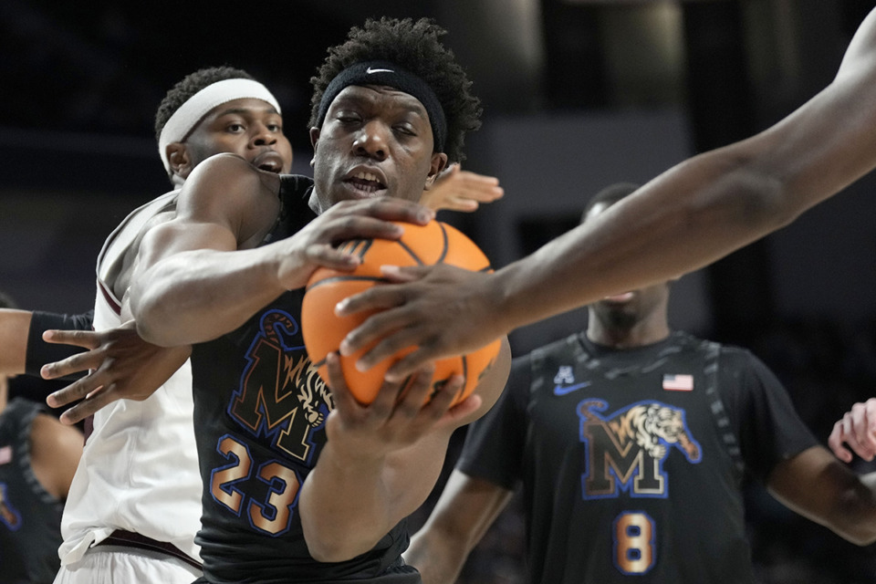 <strong>Memphis forward Malcolm Dandridge (23) grabs a rebound away from Texas A&amp;M forward Wildens Leveque (10) during the first half of an NCAA game, Sunday, Dec. 10, in College Station, Texas.</strong> (Sam Craft/AP Photo)