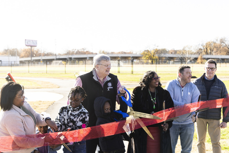 <strong>Memphis Mayor Jim Strickland, center, helps cut the ribbon during the ribbon-cutting ceremony at the new Liberty Pocket Park. The park includes new fields for soccer and football.</strong> (Brad Vest/Special to The Daily Memphian)