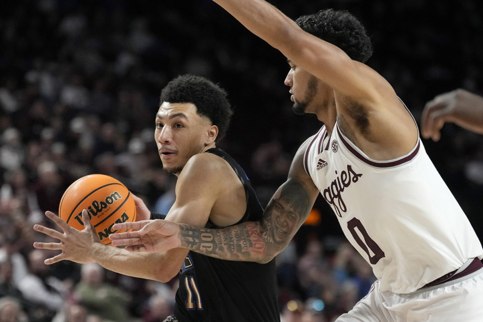 <strong>Memphis guard Jahvon Quinerly (11) drives the lanes against Texas A&amp;M guard Jace Carter (0) during the second half of an NCAA game Sunday, Dec. 10, 2023, in College Station, Texas.</strong> (Sam Craft/AP Photo)