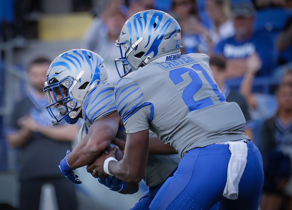 <strong>University of Memphis quarterback Tevin Carter (21) announced his commitment to Tennessee State. Carter fakes a handoff during a Nov. 4, 2023 game against USF.</strong> (Patrick Lantrip/The Daily Memphian file)