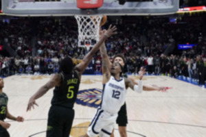 <strong>Memphis Grizzlies guard Ja Morant (12) goes to the basket between New Orleans Pelicans forward Herbert Jones (5) and guard Dyson Daniels for the game winning shot at the buzzer in the second half of an NBA basketball game in New Orleans, Tuesday, Dec. 19. The Grizzlies won 115-113.</strong> (Gerald Herbert/AP Photo)