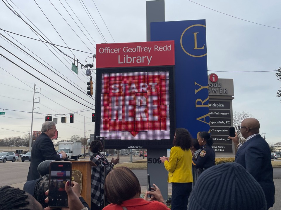 <strong>Memphis officials unveil the new sign for the Officer Geoffrey Redd Library, 5094 Poplar Ave. Memphis Police Department Officer Redd died Feb. 18, two weeks after being shot by a suspect while responding to a disturbance call.</strong> (Julia Baker/The Daily Memphian)