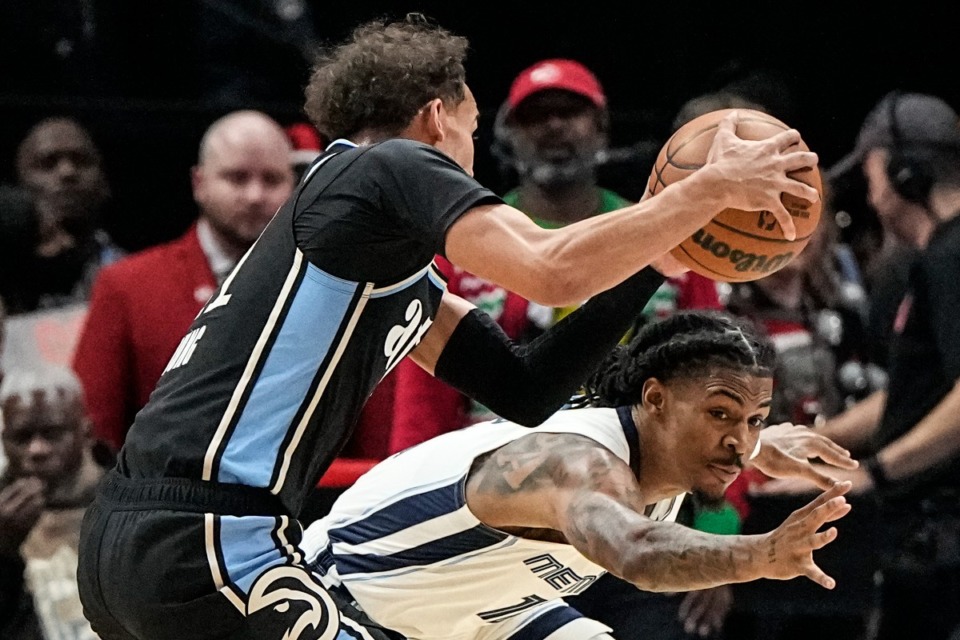 <strong>Memphis Grizzlies guard Ja Morant (12) defends against Atlanta Hawks guard Trae Young (11) during the first half of an NBA basketball game, Saturday, Dec. 23, 2023, in Atlanta.</strong> (AP Photo/Mike Stewart)