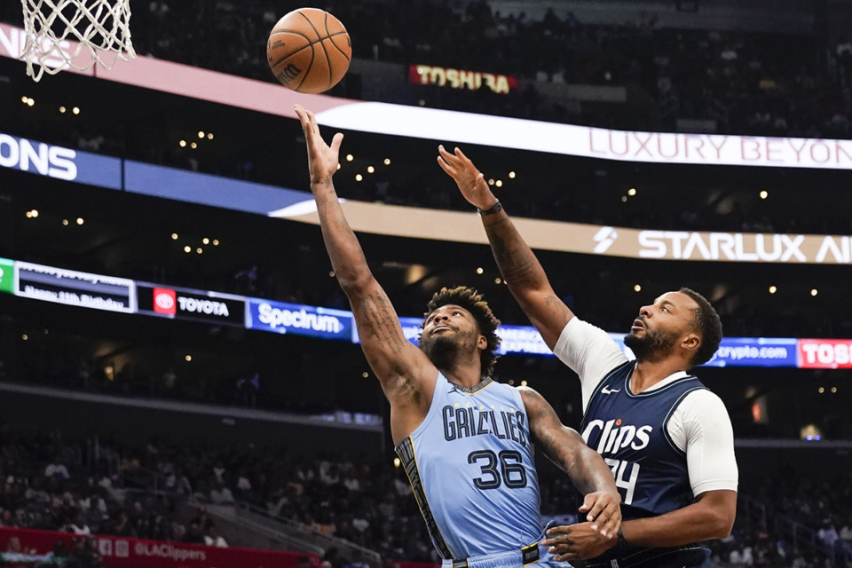 <strong>Memphis Grizzlies guard Marcus Smart, left, shoots past Los Angeles Clippers guard Norman Powell during the second half of an NBA basketball game, Sunday, Nov. 12, 2023, in Los Angeles.</strong> (Ryan Sun/AP Photo)