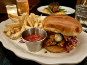 <strong>The chicken sandwich at Public Bistro is a crispy chicken thigh topped with slaw and a spicy aoili with a side of fries and a pickle.</strong> (Joshua Carlucci/Special to The Daily Memphian)