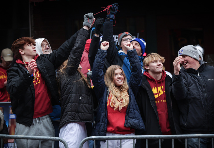 <strong>A group of Iowa State fans jostle for a string of beads during the AutoZone Liberty Bowl on Beale Street Parade Dec. 28, 2023.</strong> (Patrick Lantrip/The Daily Memphian)