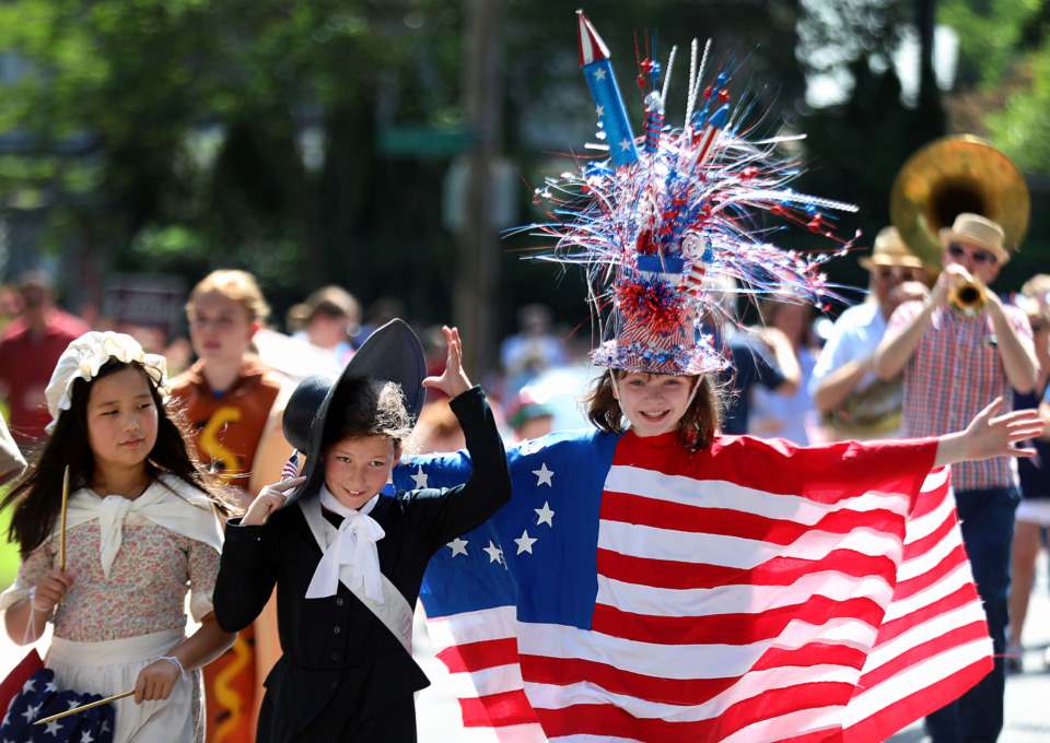 <strong>Dressed as Betsy Ross, Susan B. Anthony, and the original American flag respectively, Ellie Palmer, Virginia Smart and Lilly Loggin lead the Central Gardens neighborhood&rsquo;s Fourth of July parade Thursday, July 4, 2019.</strong> (Patrick Lantrip/Daily Memphian)