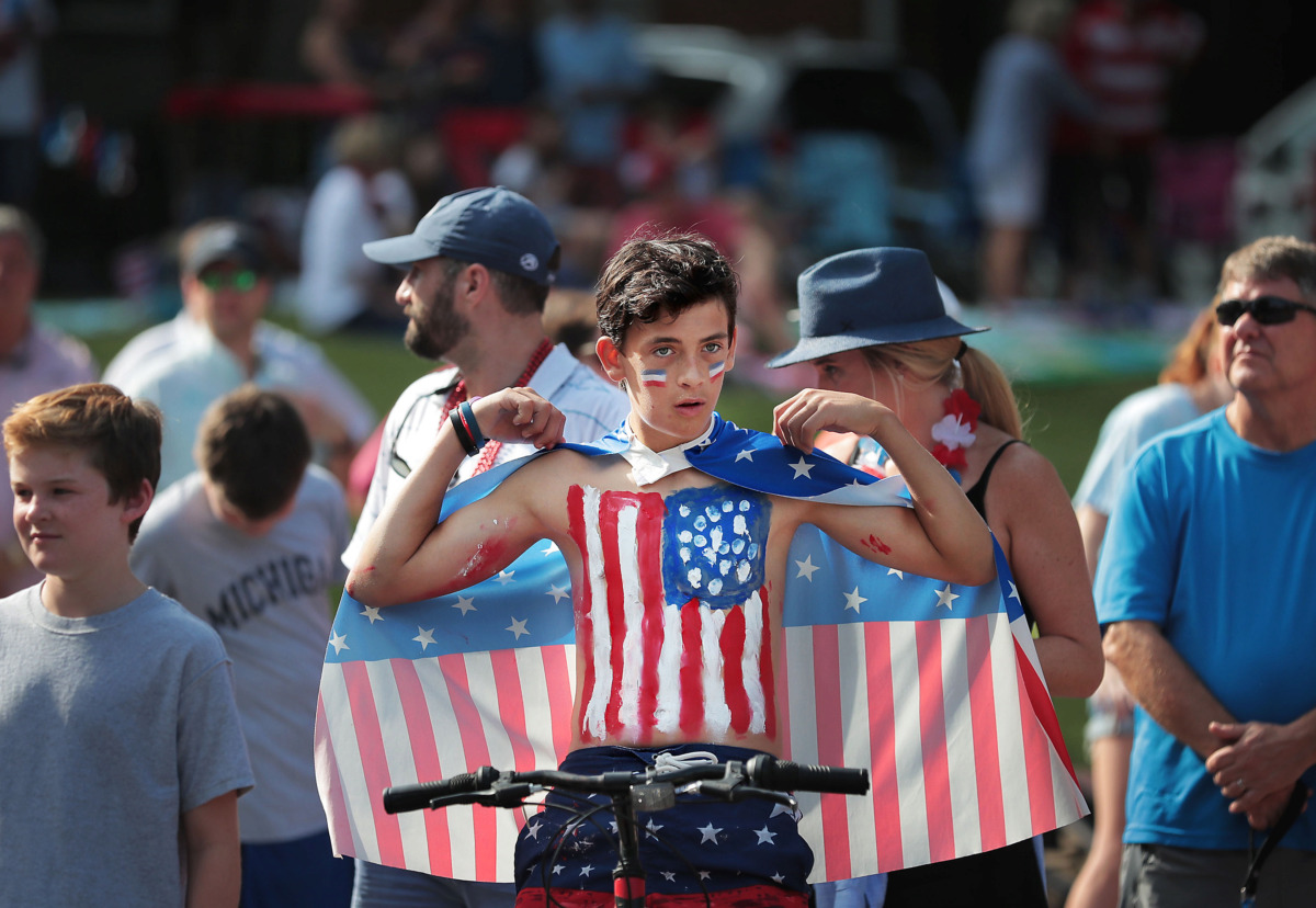 <strong>C.J. Weaver adjusts his cape as folks line up for the 70th annual Independence Day Parade in the High Point Terrace neighborhood on July 4, 2019. East Memphis residents gathered for a patriotic morning of star-spangled bikes, waving neighbors and a dousing by the Memphis Fire Department.</strong> (Jim Weber/Daily Memphian)